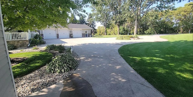 exterior space with a garage and a lawn