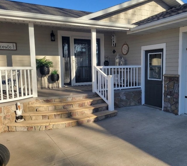 view of exterior entry with covered porch