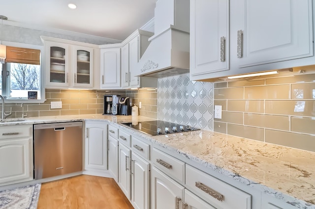 kitchen with custom exhaust hood, stainless steel dishwasher, and white cabinets