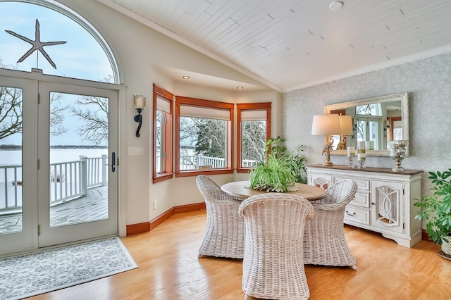 dining room with lofted ceiling, wood ceiling, ornamental molding, and light hardwood / wood-style floors