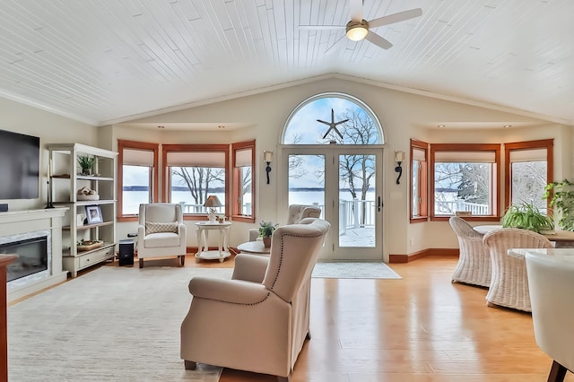 living room featuring vaulted ceiling, a fireplace, ceiling fan, light hardwood / wood-style floors, and wooden ceiling