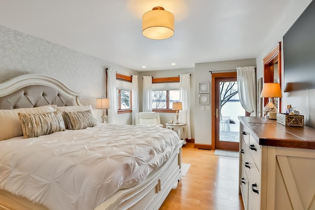 bedroom with access to outside and light hardwood / wood-style flooring