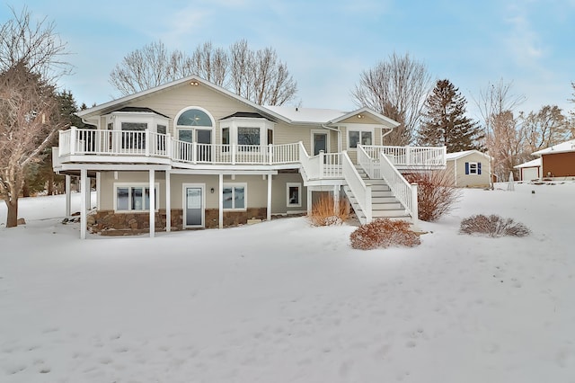 snow covered house with a deck