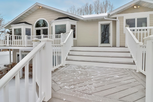 view of exterior entry featuring a deck