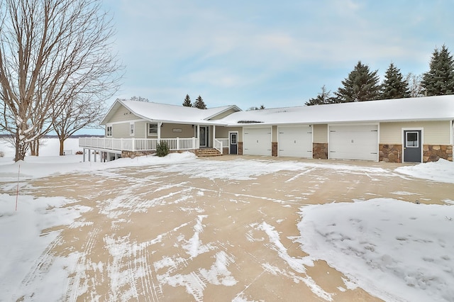 ranch-style home featuring a garage and covered porch