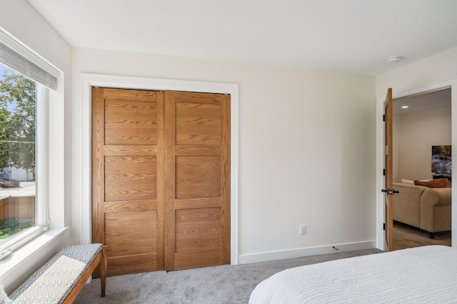 carpeted bedroom with a closet