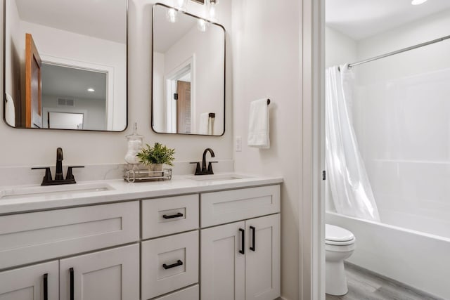 full bathroom featuring shower / tub combo, vanity, wood-type flooring, and toilet