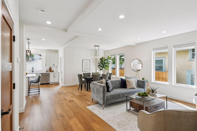 living room with a notable chandelier and light hardwood / wood-style flooring