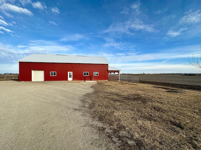 view of outdoor structure with a garage and a rural view