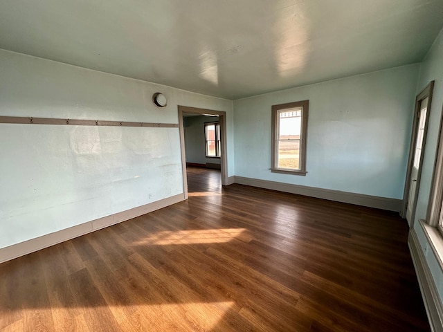 empty room with dark hardwood / wood-style floors