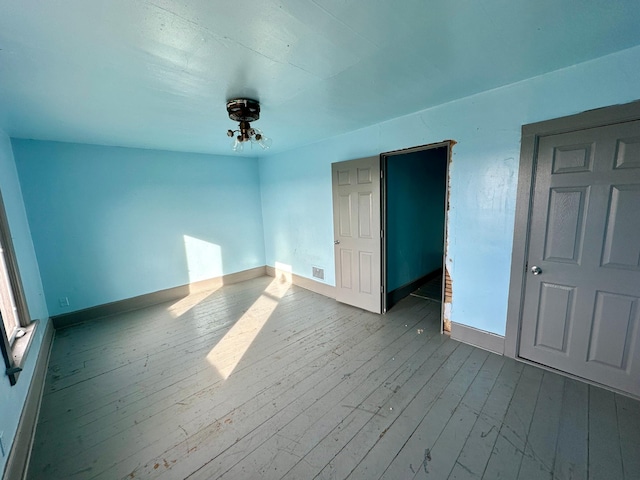 unfurnished bedroom with wood-type flooring