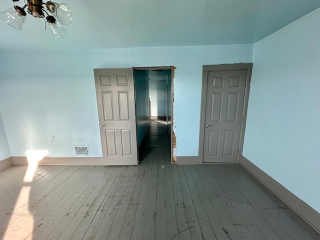 spare room featuring ceiling fan and light wood-type flooring