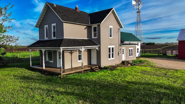 18426 County Road 18, Lewiston, MN 55952 - back of property featuring a lawn, a porch, driveway, and roof with shingles
