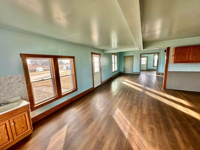 18426 County Road 18, Lewiston, MN 55952 - unfurnished living room with dark wood finished floors, baseboards, and a sink
