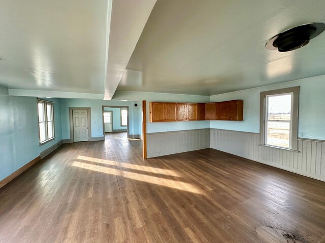 18426 County Road 18, Lewiston, MN 55952 - unfurnished living room with dark wood-style floors and wainscoting