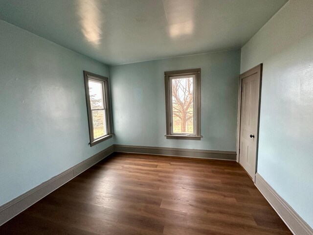 18426 County Road 18, Lewiston, MN 55952 - spare room with plenty of natural light, dark wood-style flooring, and baseboards