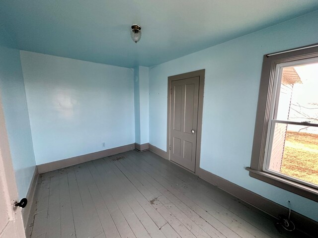 18426 County Road 18, Lewiston, MN 55952 - spare room with wood-type flooring, healthy amount of natural light, and baseboards