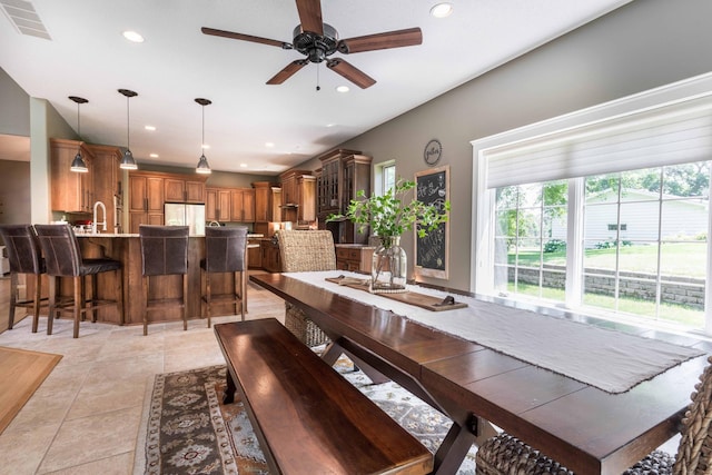 tiled dining room with sink and ceiling fan