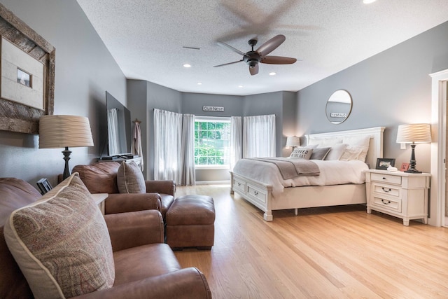 bedroom featuring ceiling fan, a textured ceiling, and light hardwood / wood-style flooring