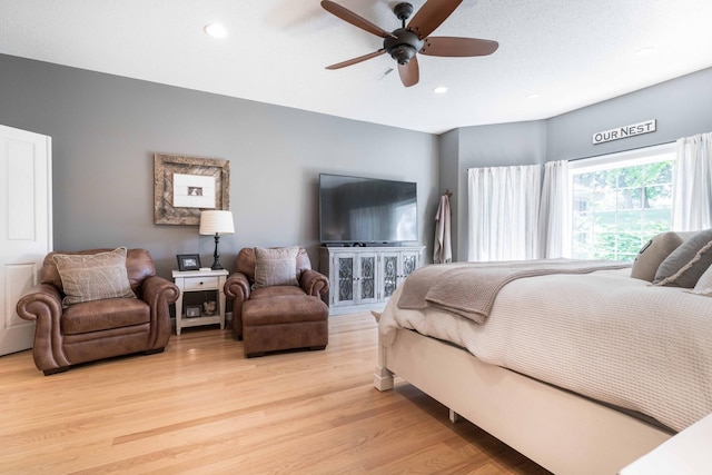 bedroom featuring ceiling fan and light hardwood / wood-style flooring