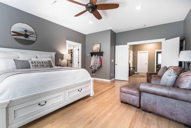 bedroom with light hardwood / wood-style flooring and ceiling fan