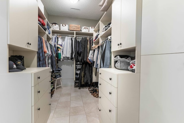 walk in closet featuring light tile patterned flooring