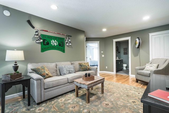 living room with hardwood / wood-style floors and a textured ceiling