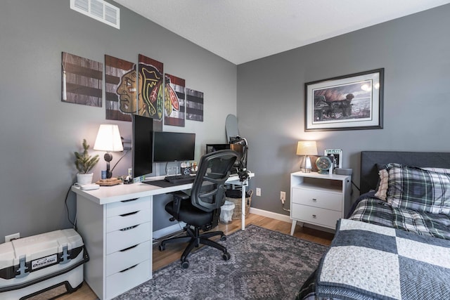 bedroom with hardwood / wood-style floors