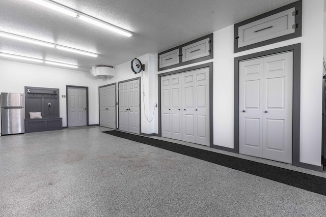 garage featuring stainless steel refrigerator