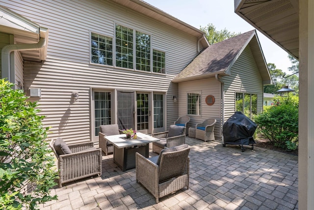 view of patio featuring a grill and an outdoor living space with a fire pit