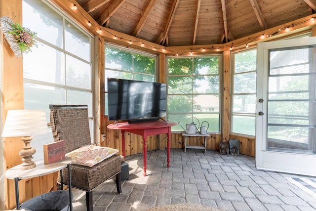 sunroom with lofted ceiling with beams and wooden ceiling