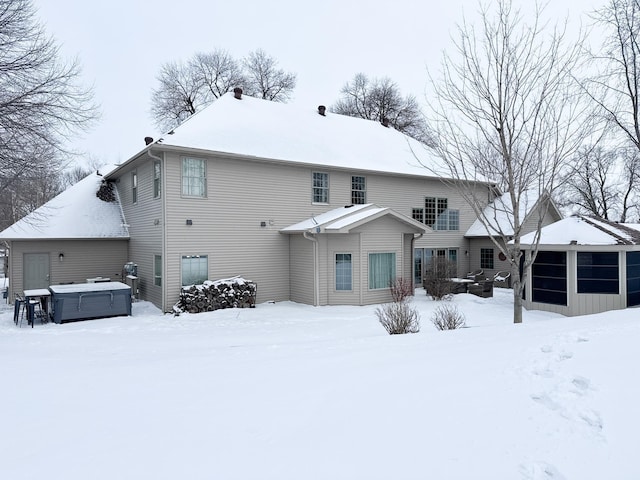 snow covered house with a hot tub