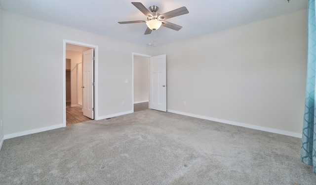 unfurnished bedroom with ceiling fan and light carpet