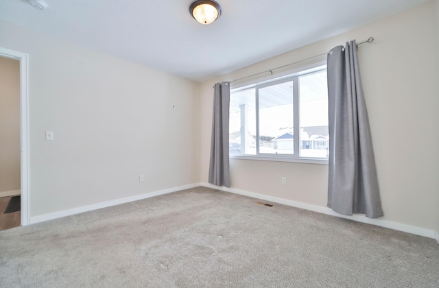 empty room with light colored carpet