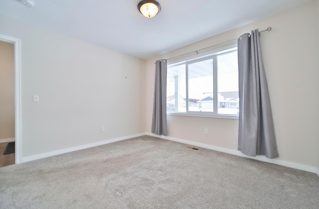 empty room with carpet flooring and baseboards