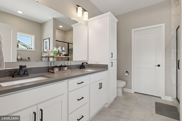 bathroom featuring walk in shower, vanity, and toilet