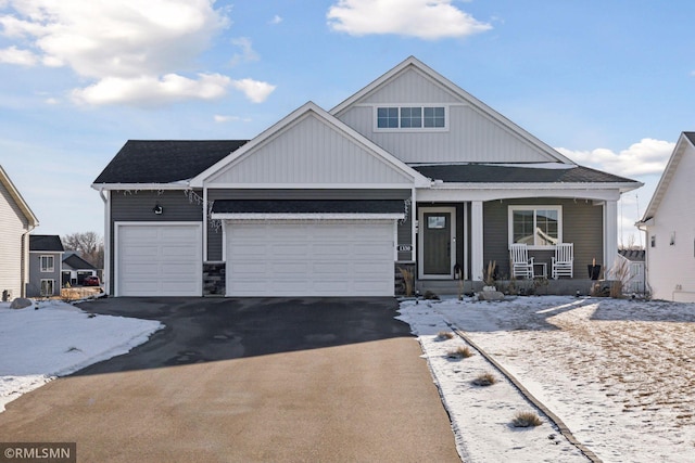 view of front of property featuring a garage and covered porch