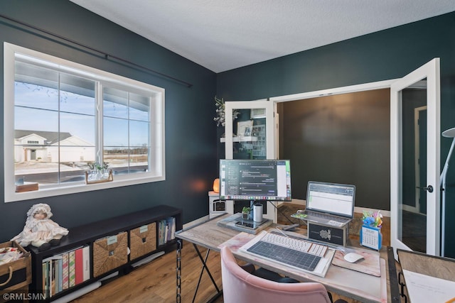 office featuring hardwood / wood-style flooring and a textured ceiling