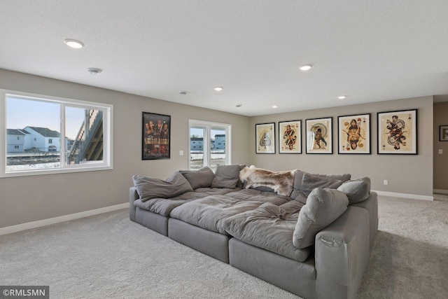 cinema room featuring carpet flooring and a textured ceiling