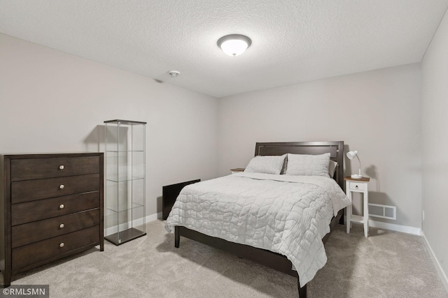 carpeted bedroom featuring a textured ceiling