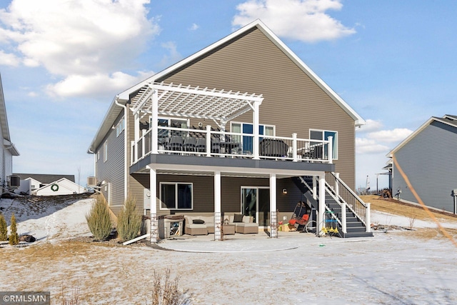 back of property with an outdoor living space and a pergola