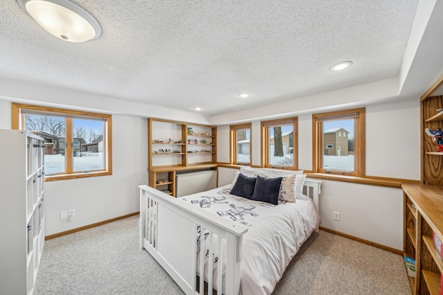 carpeted bedroom with a textured ceiling