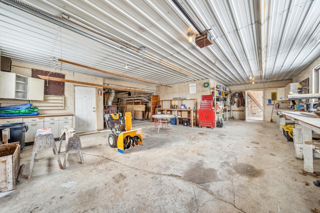 garage featuring a garage door opener and a workshop area