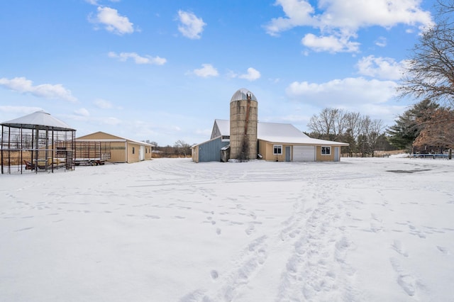 snow covered property with a garage