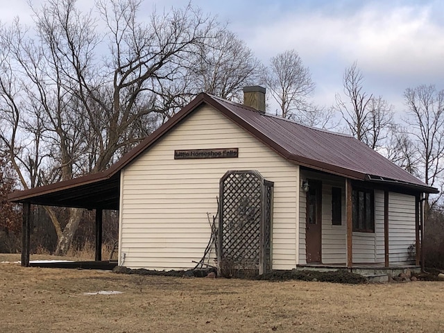 view of outbuilding featuring an attached carport