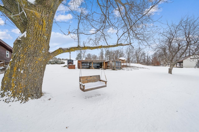 view of snow covered back of property