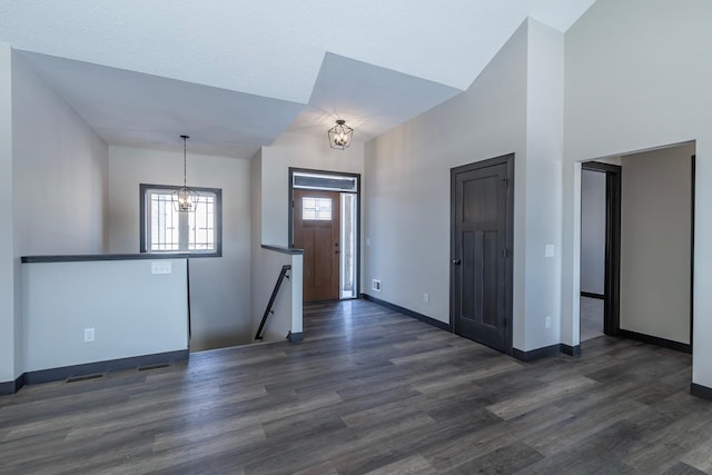 entryway featuring dark hardwood / wood-style floors and a notable chandelier