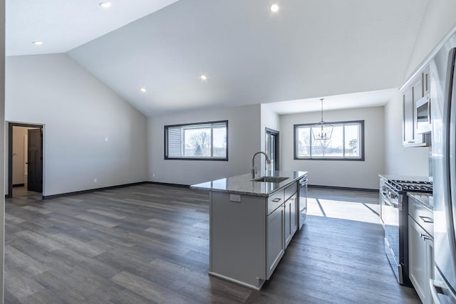 kitchen with sink, gray cabinetry, an island with sink, pendant lighting, and stainless steel appliances