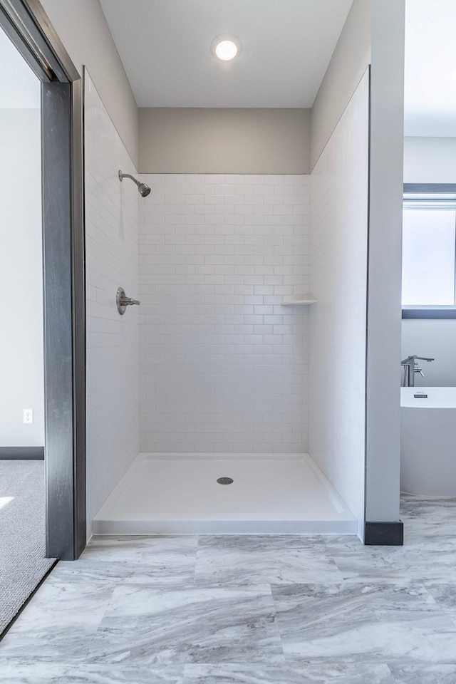 bathroom with a tile shower