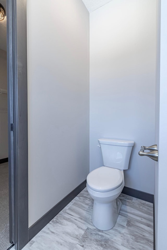 bathroom with hardwood / wood-style floors and toilet